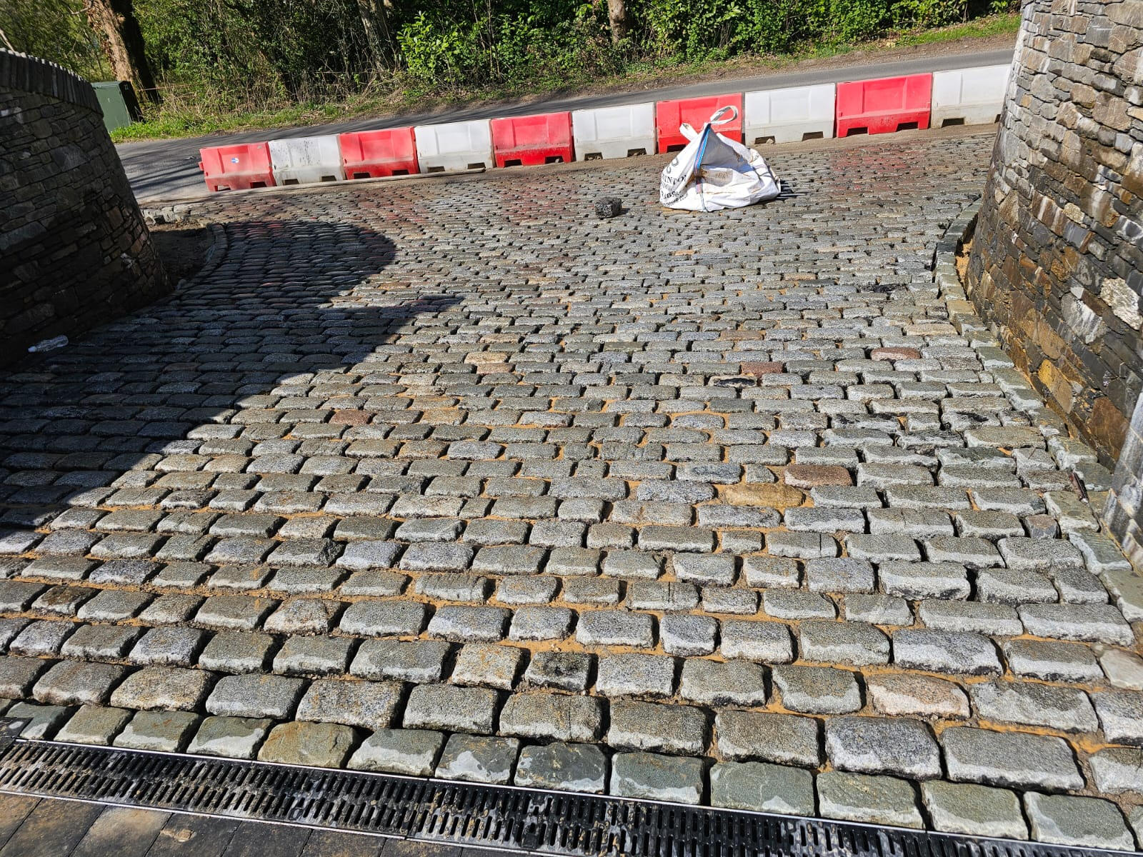 Wide view of finished cobbled driveway entrance from the road