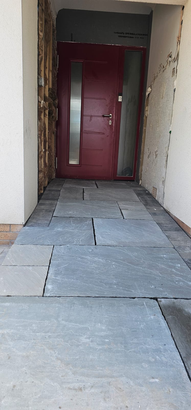 Riven slate flagstone path leading to a red front door